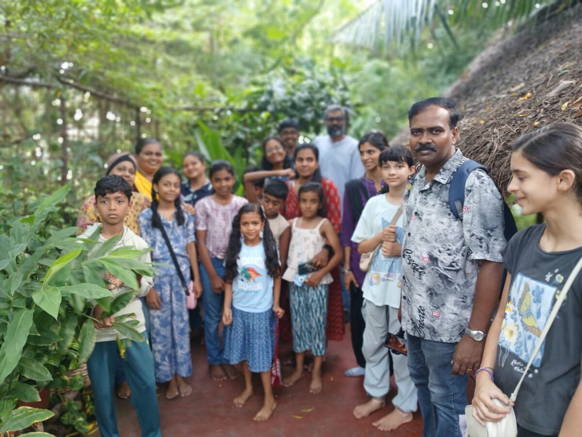 Children standing among the plants on the land at EPIC-SS